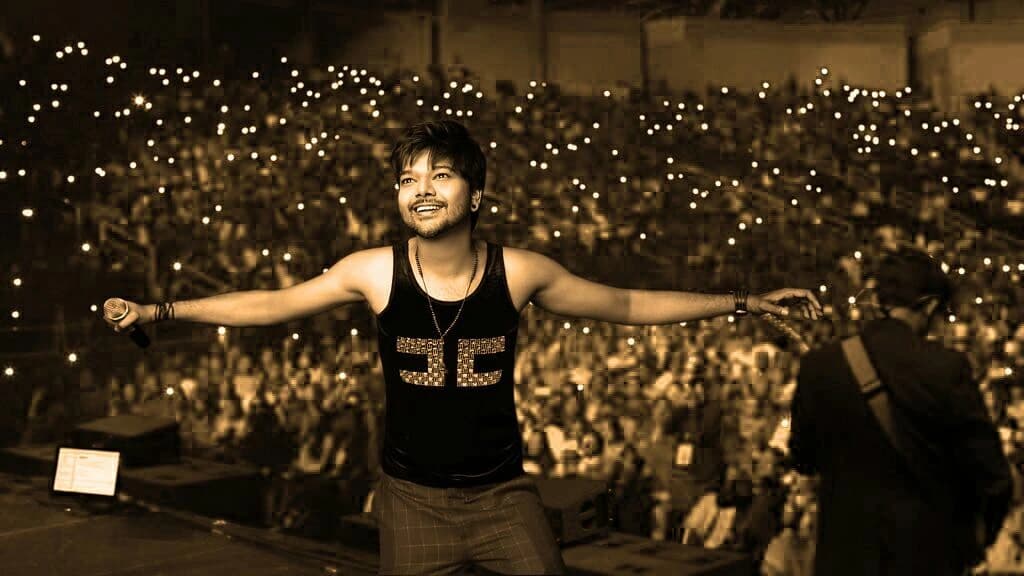 Samrat posing on stage after performance with crowd